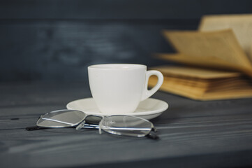 Concept on the topic of education. Books on a wooden background with coffee and glasses.