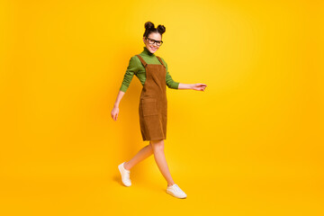 Fototapeta na wymiar Full length body size view of her she attractive lovely cheerful girl wearing casual look going back to school autumn fall season isolated bright vivid shine vibrant yellow color background