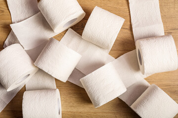 Toilet paper rolls on wooden background