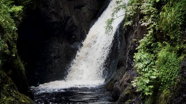 Slow-motion waterfall flowing in Glenariff Forest, Northern Ireland.