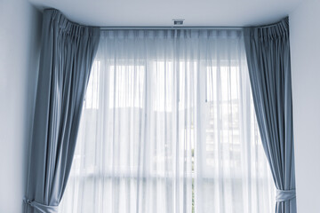 Light shines through curtains in room