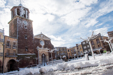Postcard of the medieval town of Prades (in Catalonia, Spain) full of snow, with the church of Santa María and its typical fountain