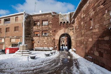 Postcard of the medieval town of Prades (in Catalonia, Spain) full of snow, with the church of Santa María