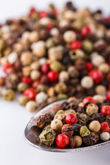 mix of peppercorns on white acrylic background