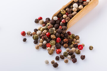 mix of peppercorns on white acrylic background