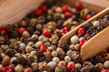mix of peppercorns on white acrylic background
