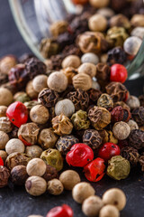 mix of peppercorns on a dark stone background