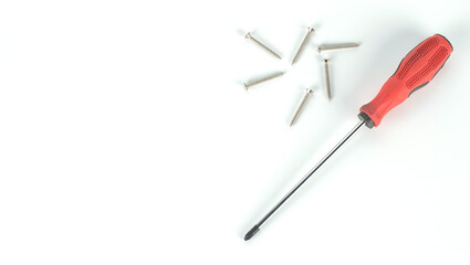 red screwdriver and nuts on white background