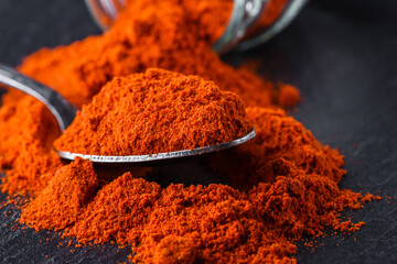 aromatic ground paprika on a dark stone background