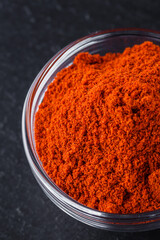 aromatic ground paprika on a dark stone background