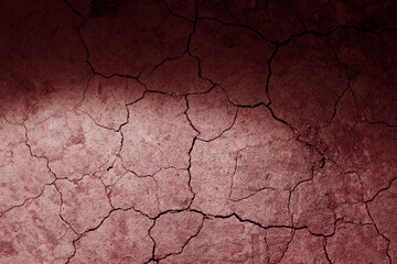 Dry cracked earth red Mars ground texture with spot light. No watering desert.
