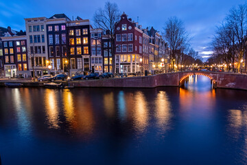 Amsterdam houses along the canal at night in the Netherlands