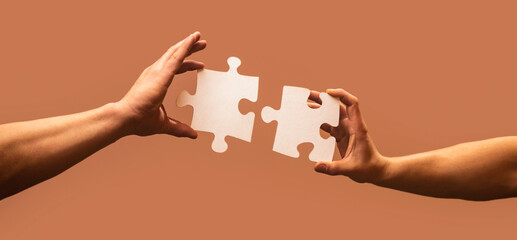 Business solutions, success and strategy concept. Man hands connecting couple puzzle piece....
