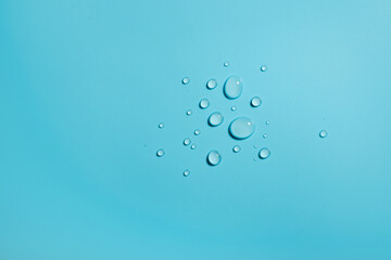 Different sized droplets on blue background