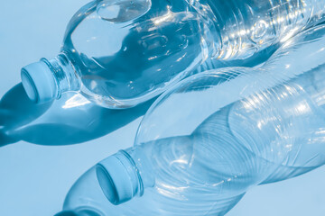 Two plastic bottles on a blue background.