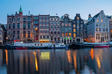 Fototapeta na wymiar Amsterdam houses and house boats along the Amstel in Amsterdam the Netherlands at sunset
