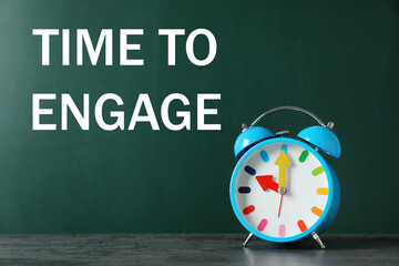 Text Time to engage on green chalkboard near alarm clock