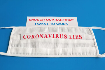 Enough quarantine, I want to work, Coronavirus Lies. The inscription on a white surgical mask on a...