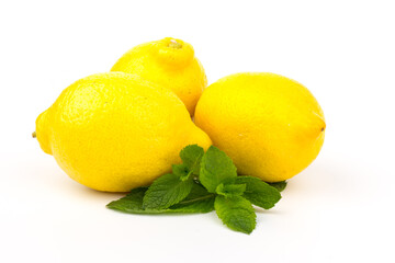 Group of lemons with mint leaves, isolated on white background