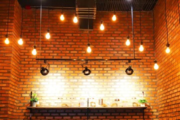 Decorating the room with brick walls with lamps is beautiful.