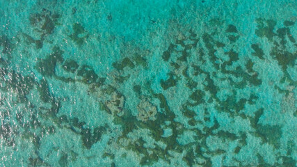 Aerial view of the beautiful ocean floor with reefs near Pantai Pandawa. Indonesia.