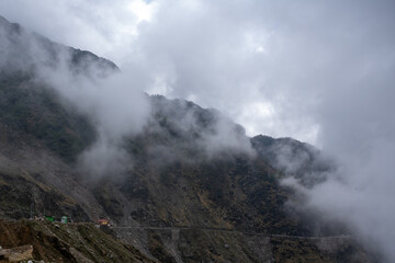 risky hilly rocky road through clouds