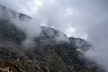 risky hilly rocky road through clouds