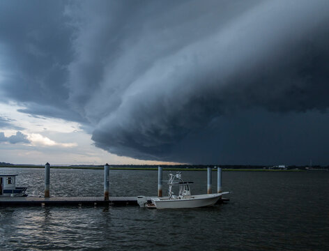 A wall cloud appraches dock and boats along the coast of South Carolina, USA.