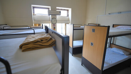 Empty room for a cheap hostel with bunk beds. - obrazy, fototapety, plakaty