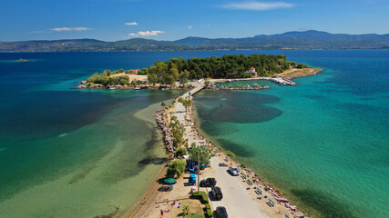 Naklejka premium Aerial drone photo of famous island of dreams or Pesonisi connecting with small road with seaside fishing village of Eretria, Central Evia island, Greece