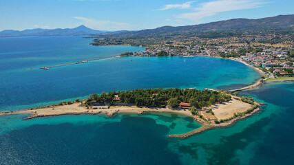 Fototapeta na wymiar Aerial drone photo of famous island of dreams or Pesonisi connecting with small road with seaside fishing village of Eretria, Central Evia island, Greece