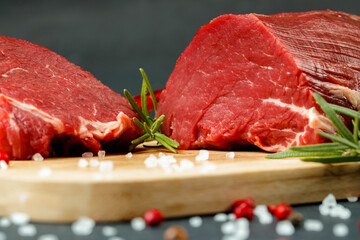 Slice of raw beef fillet on wooden board