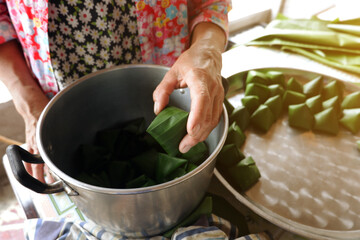 Making Thai folk sweets wrapped in banana leaves Due to the Thai New Year festival