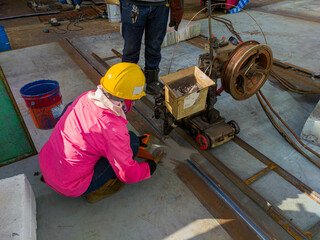 The welder is welding add joint a steel plate with process Submerged Arc Welding(SAW) at industrial factory.