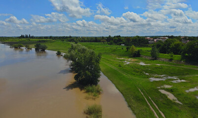 Fototapeta na wymiar Water flowing in farm field waterway on field flooded damage after heavy rain