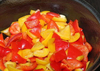 sliced red and yellow capsicum on a bowl