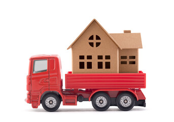 Red truck miniature with house on white background