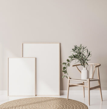 Mock up poster frame close up in Scandinavian style home interior. Two wooden frames standing on floor with wooden chair and Eucalyptus plant 3d render
