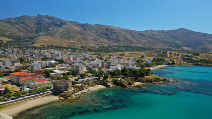 Obraz premium Aerial drone photo of famous seaside town and port of Karistos in South Evia island, Greece