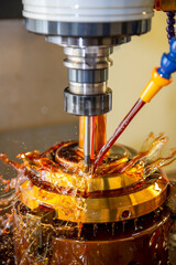 The CNC milling machine cutting the tire mold parts with liquid oil coolant method in vertical...