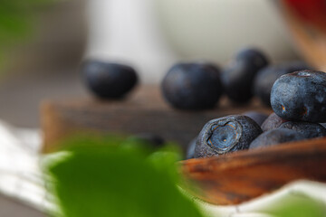 Bowl of fresh blueberry on kitchen table close up