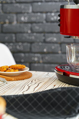 Red coffee machine with a glass on kitchen counter
