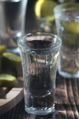 Three shots with vodka and pickled cucumbers