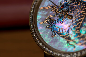 Fototapeta na wymiar luxury watches with iridescent pearl pearl. Limited hours with the Chinese dragon. Luxury gold diamond watches. Mosaic clock