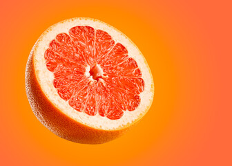Grapefruit closeup isolated on orange background. Very detailed macro shoot with subject on left and copy space on right.
