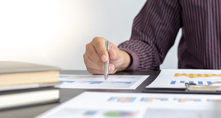 Fototapeta premium Young business men analysis graph data in the office.