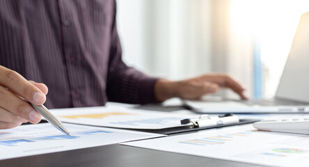 Young business men analysis graph data in the office.