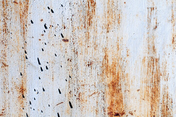Background. Rusty metal surface. The silver paint was peeling. The iron is oxidized. Orange stripes, black drops.