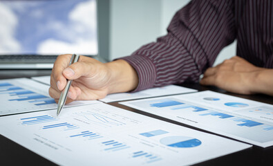 Young business men analysis graph data in the office.