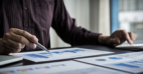 Young business men analysis graph data in the office.